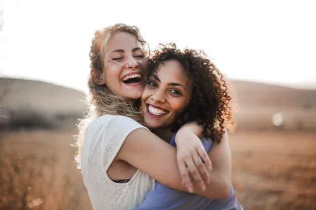 two women hugging after going through addiction aftercare services