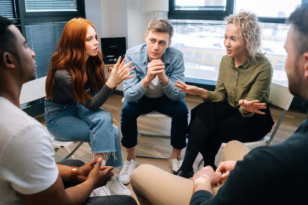 group discussing the benefits of addiction treatment programs