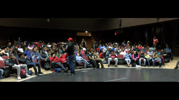 a person giving a presentation to a group of kids