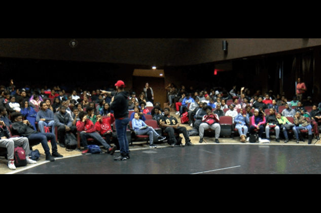 a person giving a presentation to a group of kids