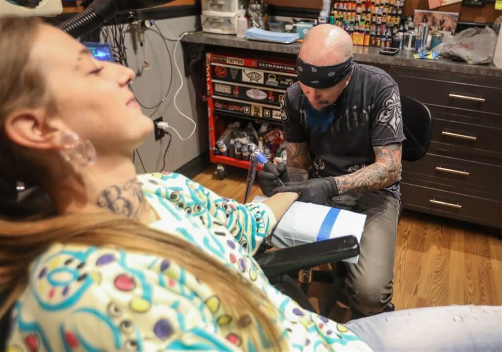 a woman getting tattooed