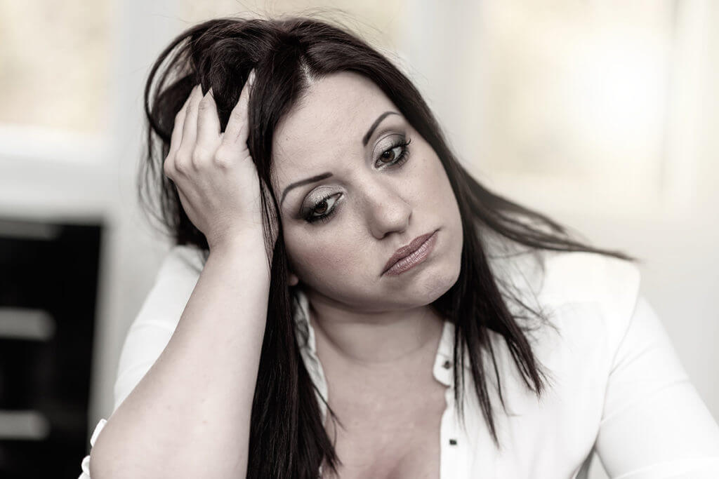 woman with Alcohol Withdrawal Symptoms leaning on her hand
