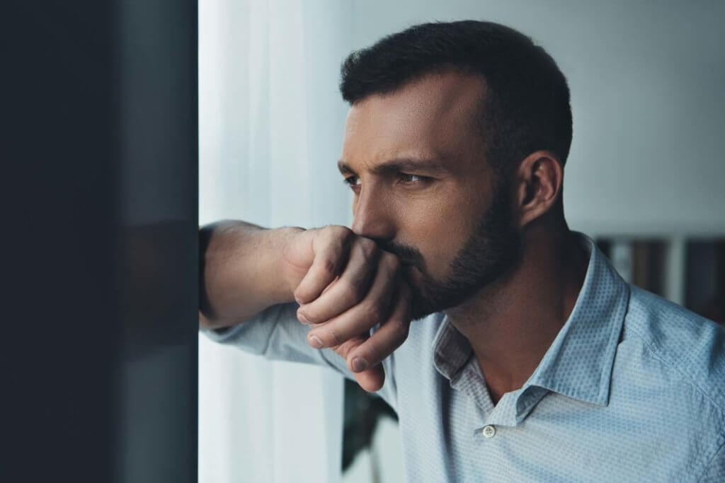 man leaning on wall wondering Do I Need a Detox Center