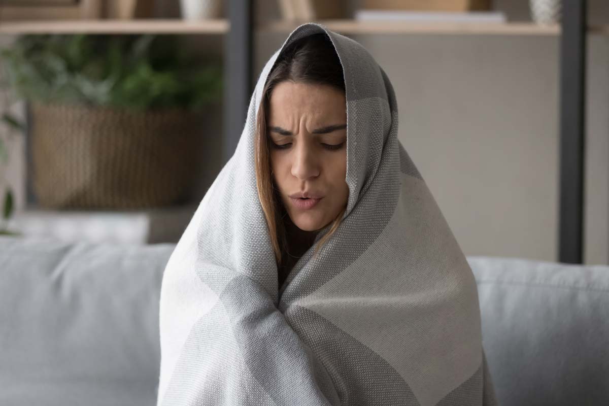 opioid-withdrawal-symptoms woman wrapped in a blanked going through Opioid Withdrawal Symptoms