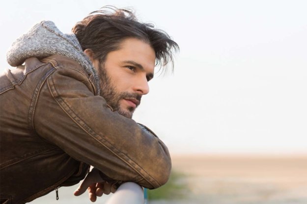 should-i-go-to-a-detox-center man leaning on a railing wondering Should I Go to a Detox Center