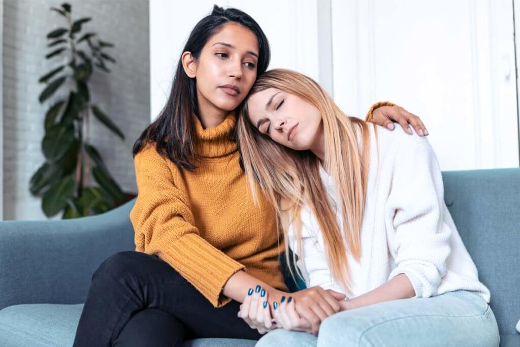 woman consoling another wondering What to Expect When a Loved One Is in Addiction Detox