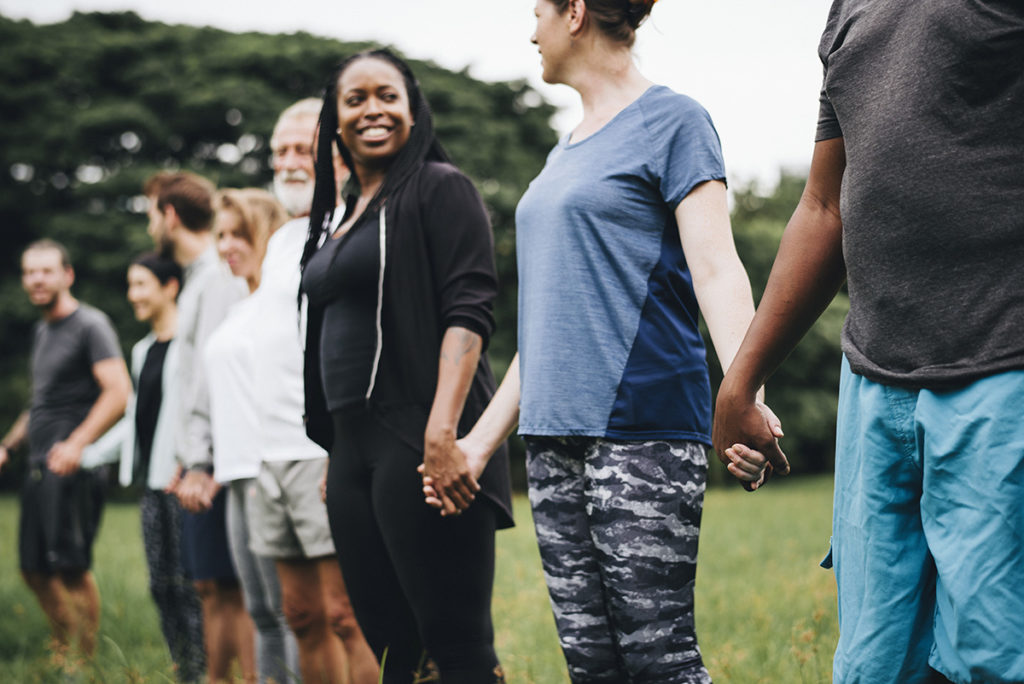 line of men and women holding hands during national recovery month
