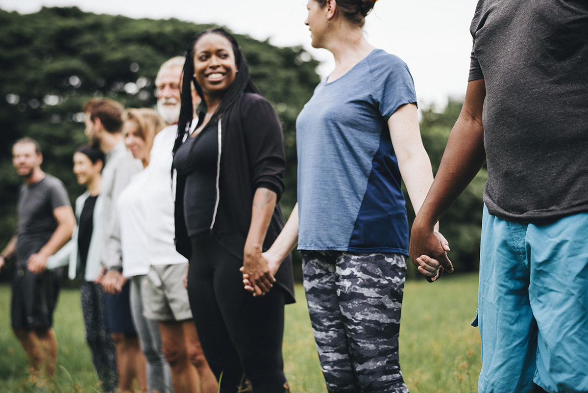 How to Make a Difference During National Recovery Month line of men and women holding hands during national recovery month
