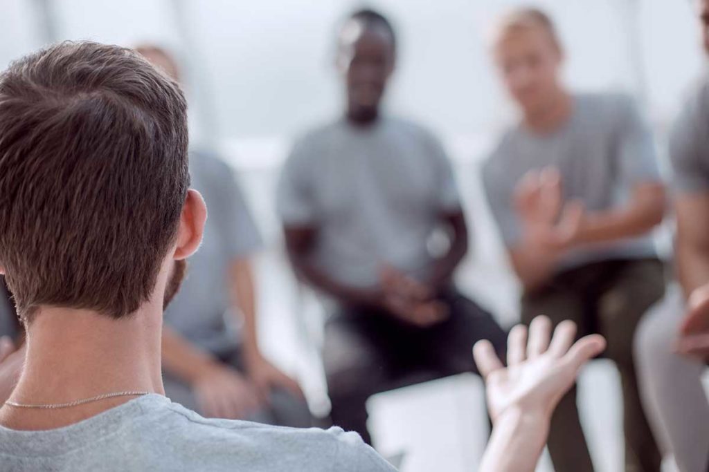 individual explaining benefits of group therapy