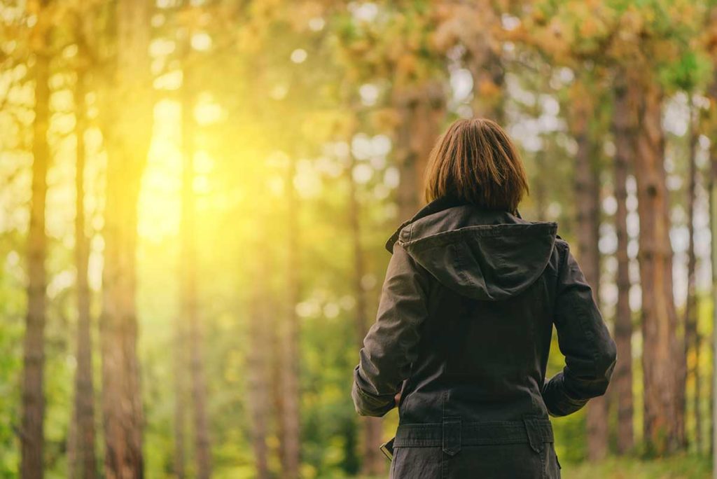 woman in the woods seeing to her mental health