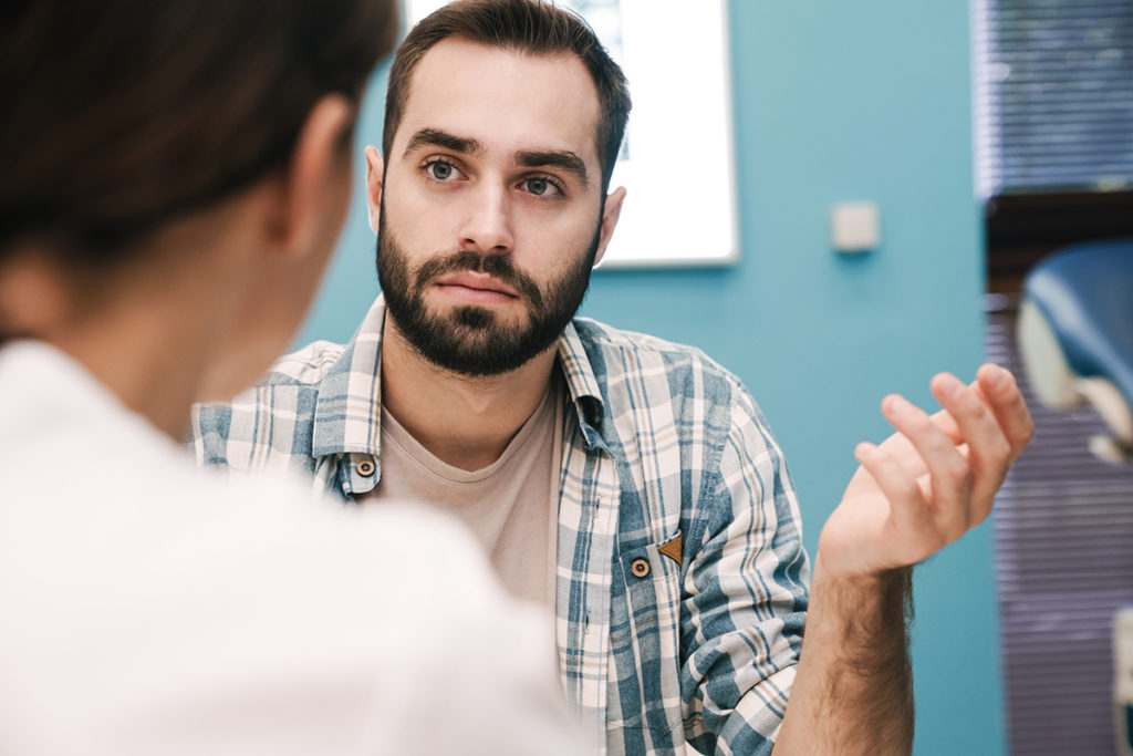 man thinks about how to talk to his family about addiction