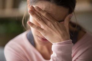woman rubbing forehead needing a Methadone Detox Center