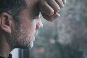 man leaning against window at Suboxone Detox Center