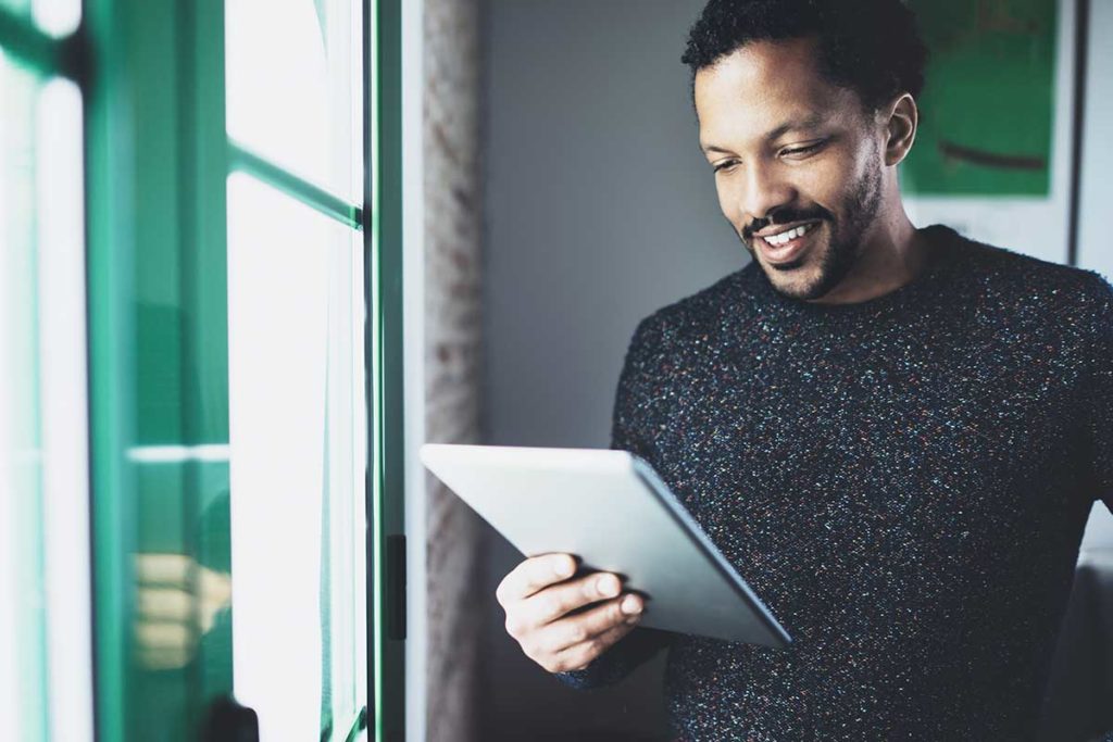 man uses a tablet, evidence of technology in recovery