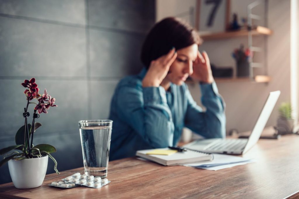 woman struggling with the symptoms of painkiller addiction