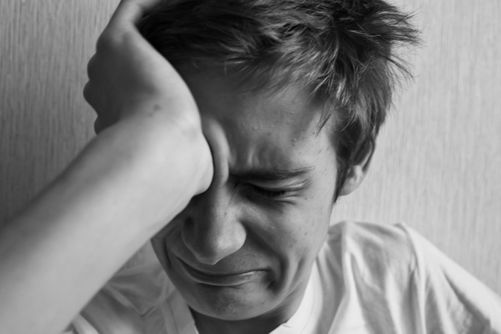 man struggles with the signs of meth addiction