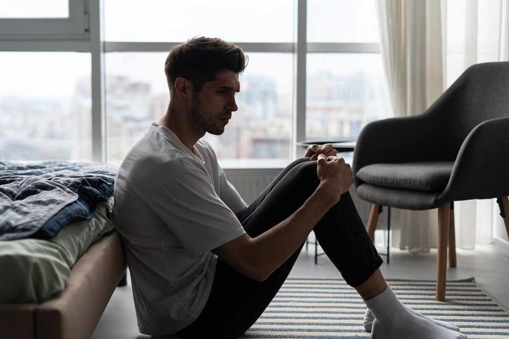 man considers the mental strain of addiction recovery