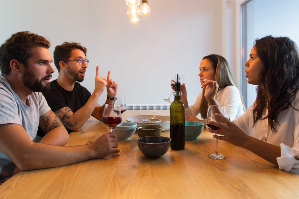 man struggles with relapse triggers of alcoholism at dinner