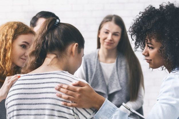 therapy group meets at residential addiction treatment center