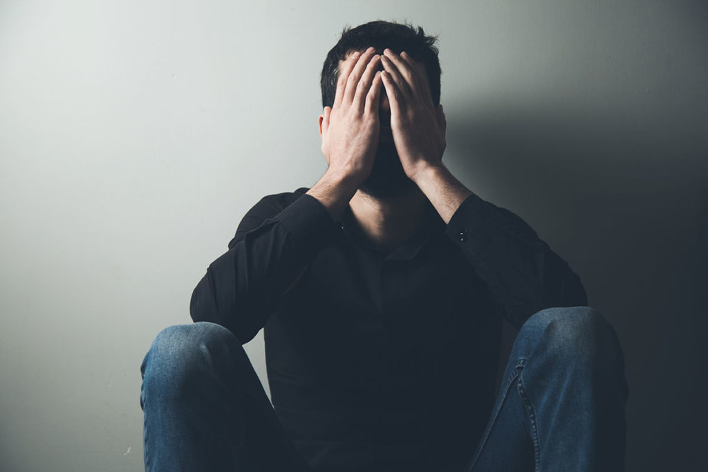 man struggles with alcohol withdrawal symptoms