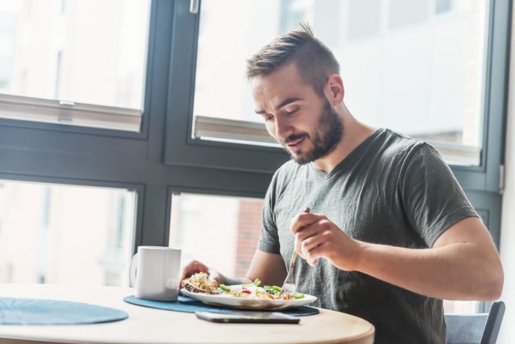 man eating to deal with detox symptoms