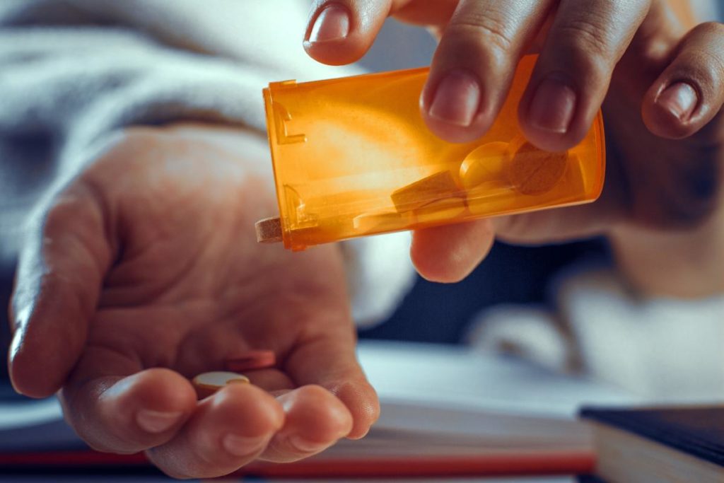 drug prescription being poured into palm