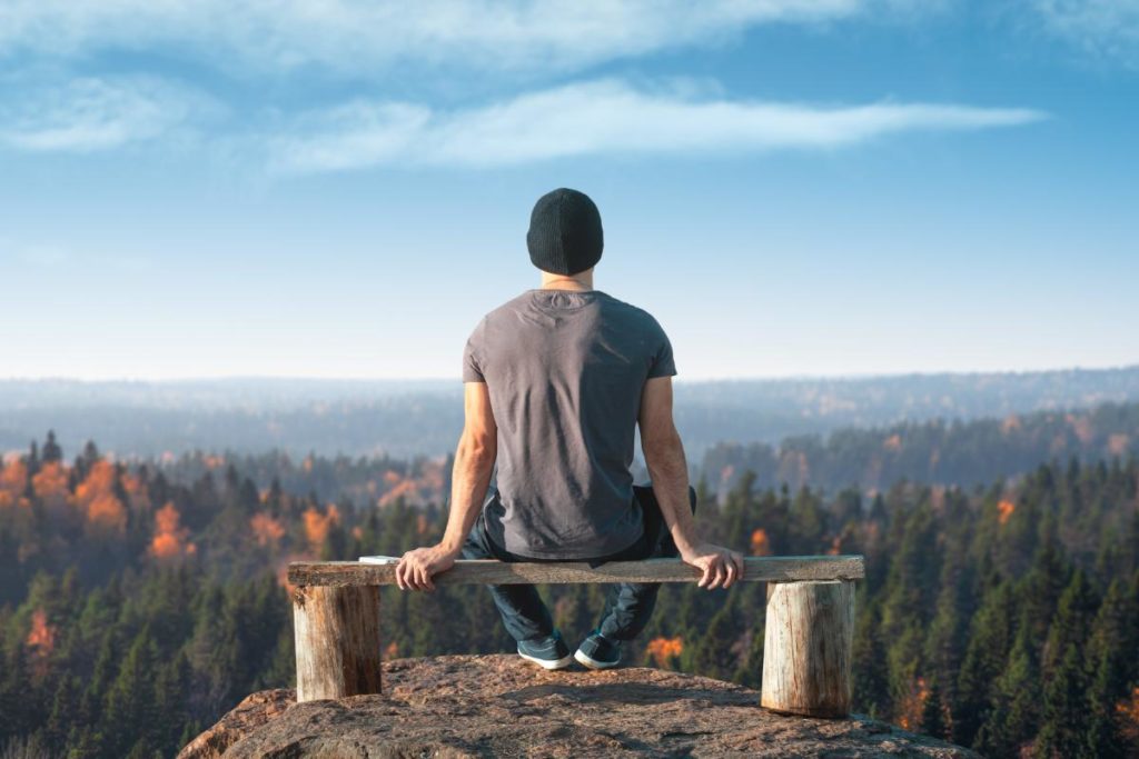 person on bench looking out over vista thanks to tips to avoid addiction relapse