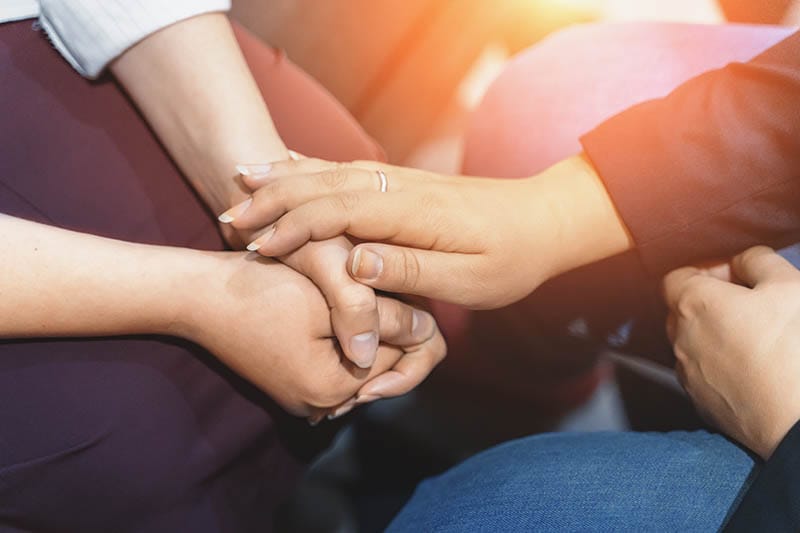 people holding hands in drug detox