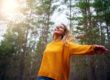 woman happy in forest showing life after drug rehab