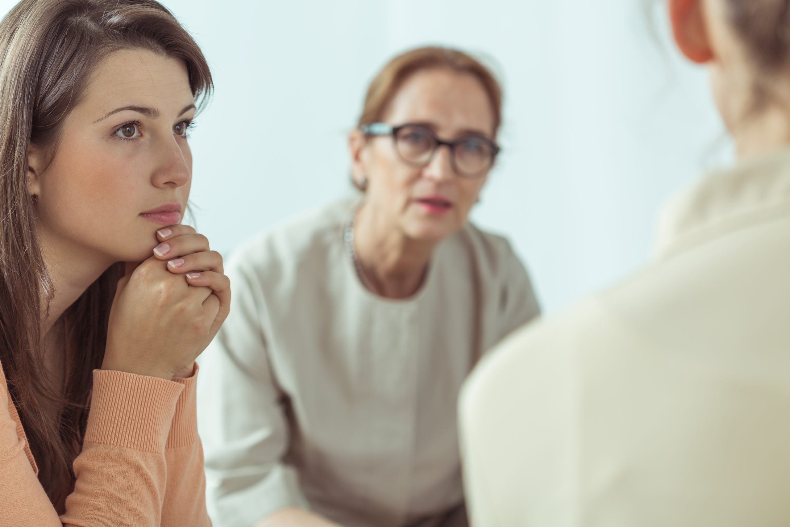 Mature spiritual guide talking with young women about medication assisted treatment