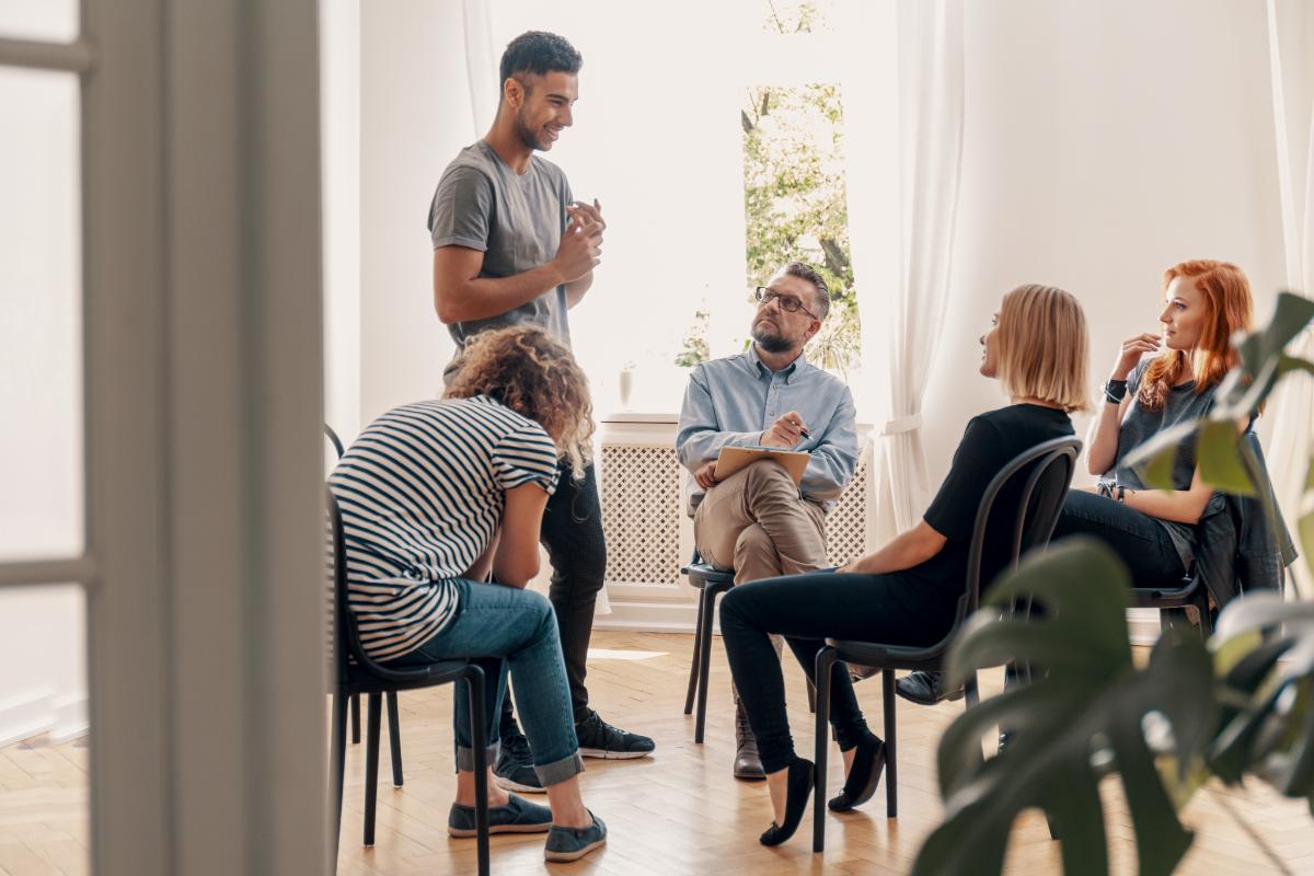 3 Common Addiction Triggers and How to Avoid Them a group talking about 3 common addiction triggers and how to avoid them