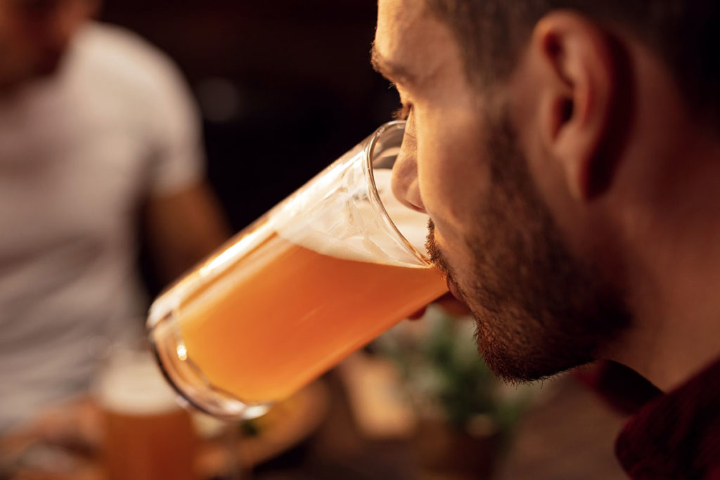 man drinking beer as sign of binge drinking