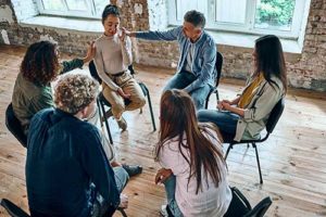 people in xanax addiction treatment program sitting in group therapy