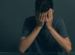 a man with his face in his hands thinking about fentanyl withdrawal symptoms